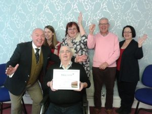 Committee members and community development manager celebrate the award of Hallmark 3